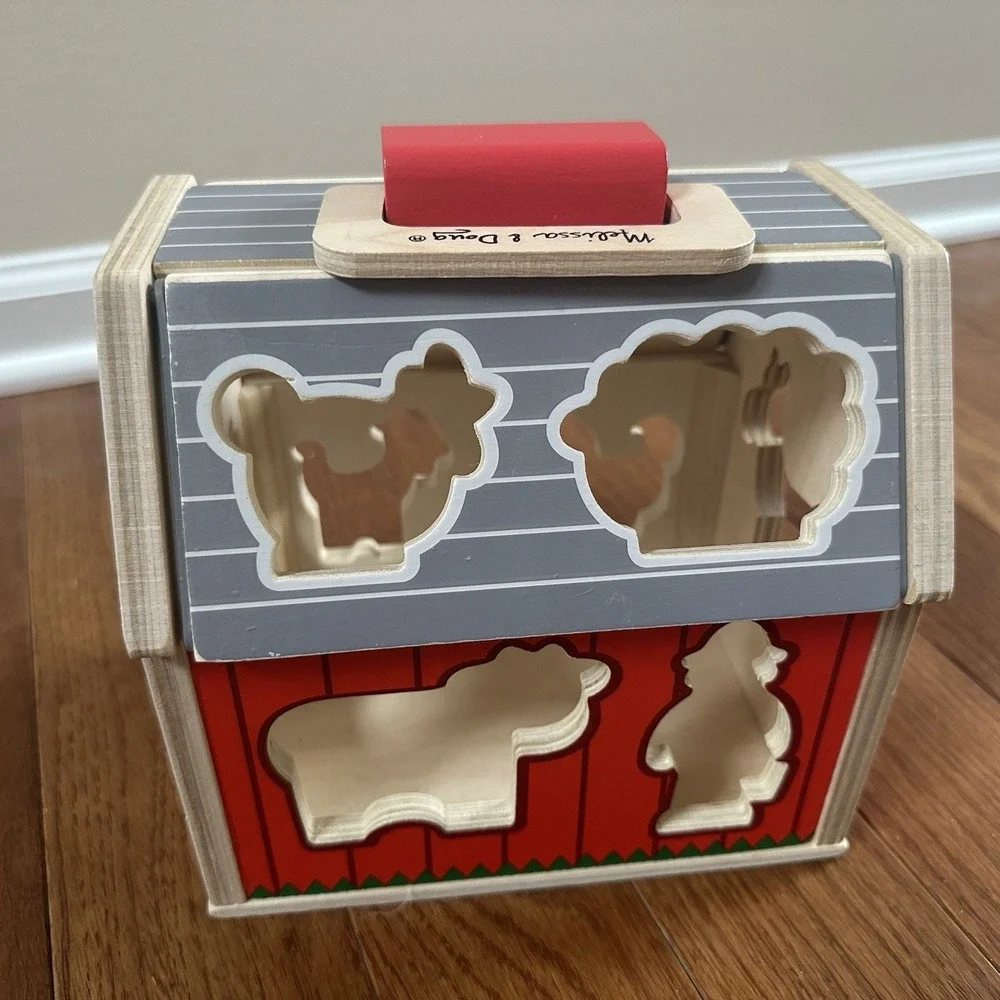 Melissa & Doug‎ Wooden Take-Along Sorting Barn Toy with Flip-Up Roof, 9 Pieces.